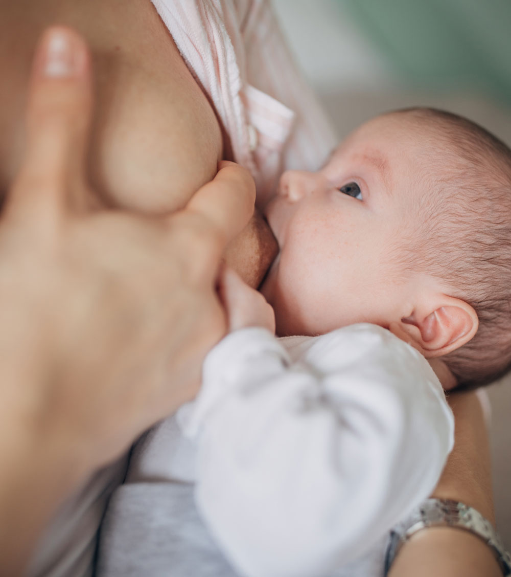 woman breastfeeding her infant child