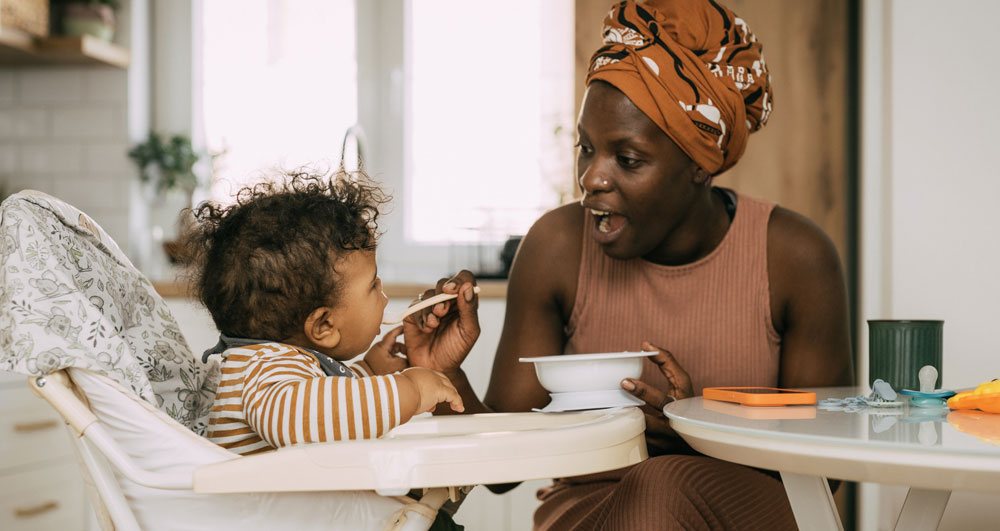 Mother feeding baby with spoon